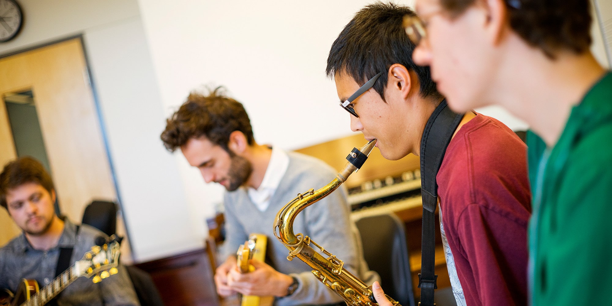 RJAM Roots Jazz and America Music students rehearsing saxophone guitar