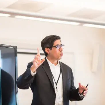 a teacher lectures at a projector