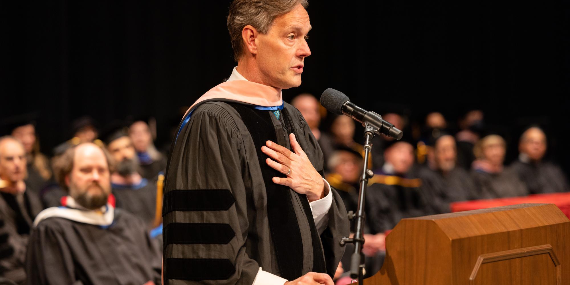 jake heggie speaks at the lectern