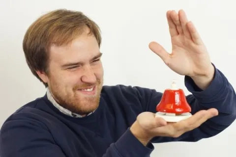 Danny Clay holding a bell