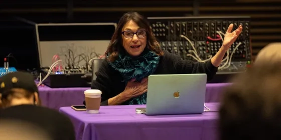 Suzanne Ciani at a table gesturing