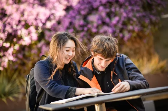 SFCM students sit outside.