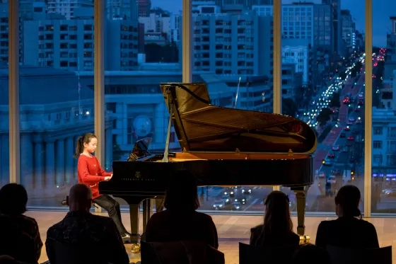 A Pre-CollegA Pre-College student plays piano in the Bowes Center.s Center.