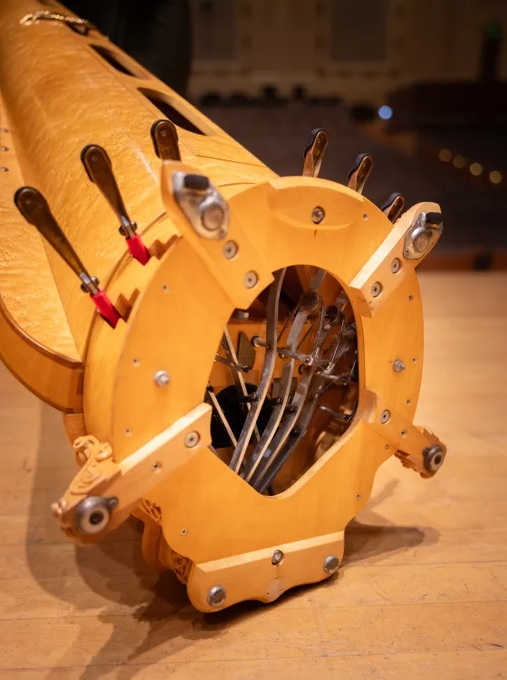 A close-up of how a concert harp's pedals are anchored in the column.