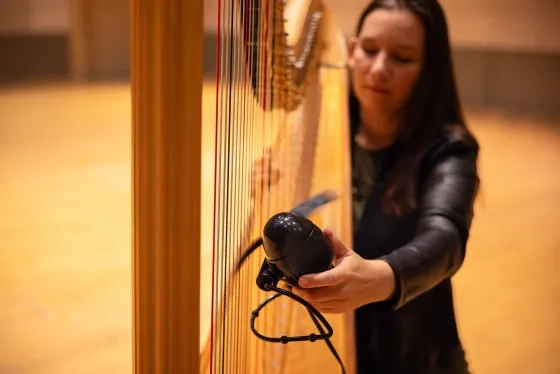 Ellis uses an electric hand-fan, one of the many extended techniques she employs on harp.