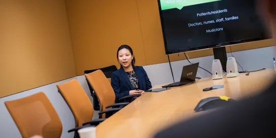 A photo of a student making a presentation at SFCM