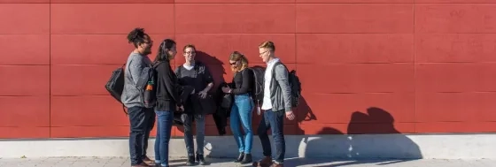 SFCM students in front of a red wall